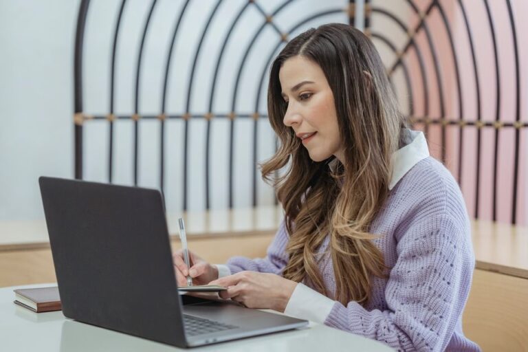 woman writing on laptop notebook