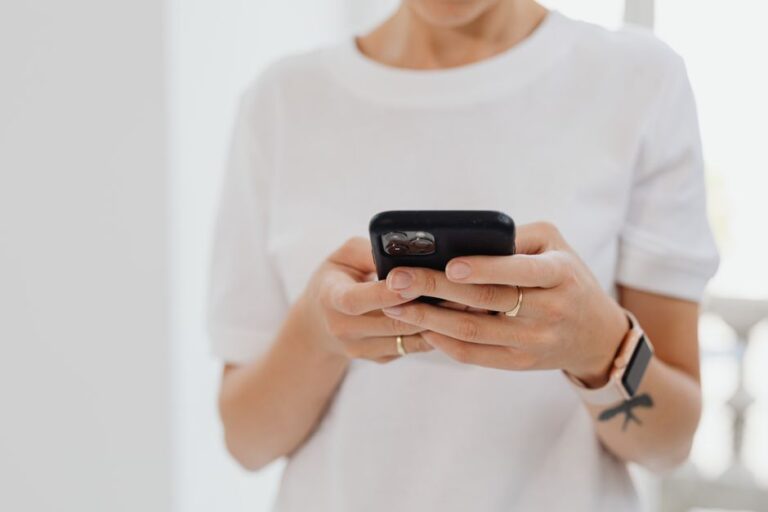 woman holding smartphone indoors
