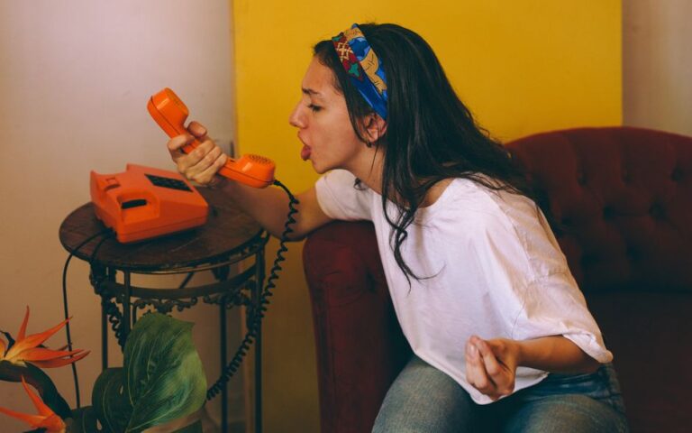 frustrated young woman with phone on couch