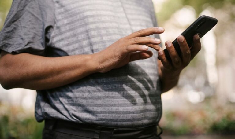 man typing on smartphone closeup
