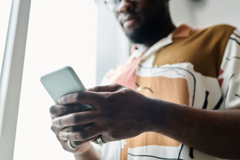 man holding smartphone closeup street