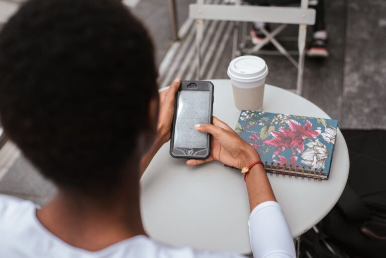 woman texting on smartphone cafe