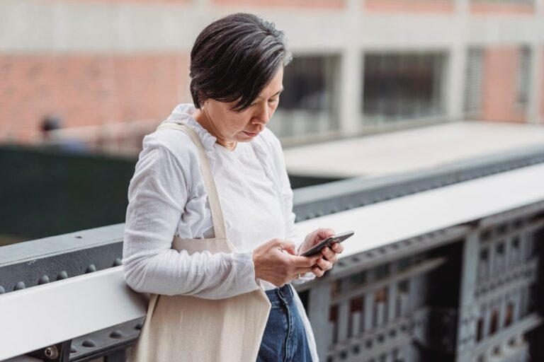 woman using smartphone outdoors city