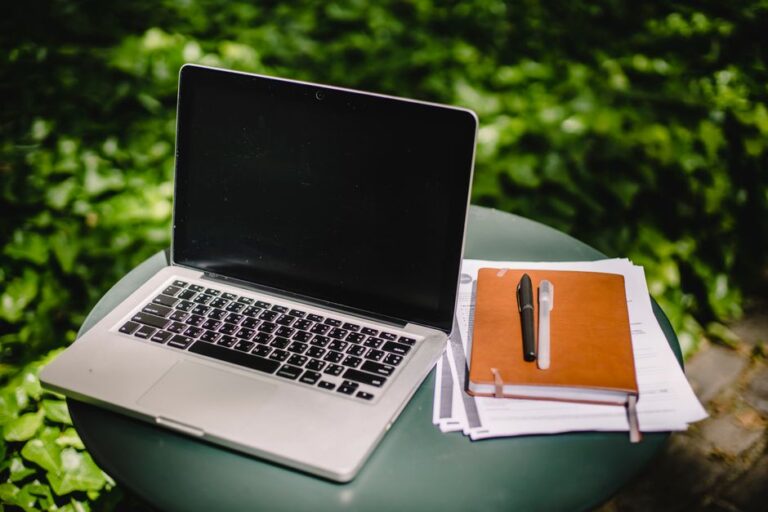 laptop on table with notebook