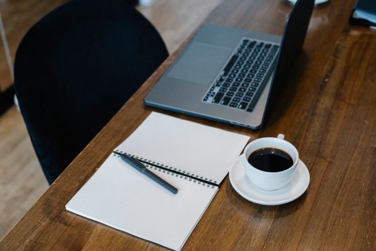 laptop and coffee cup on table