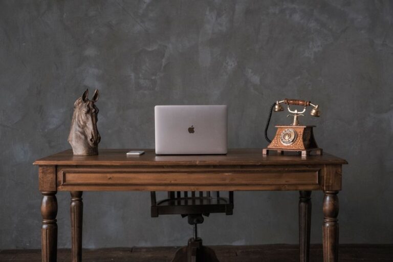 vintage laptop on wooden desk