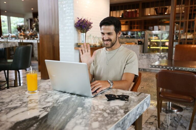 man working on laptop in cafe
