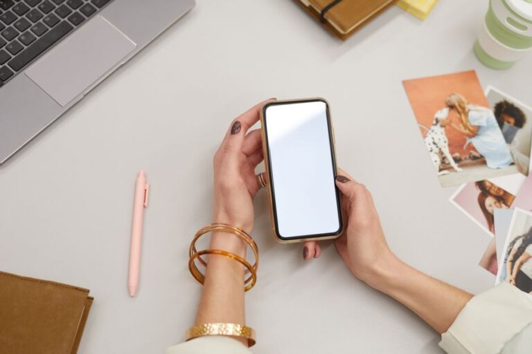 woman holding phone in office