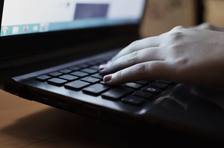 person typing laptop closeup hands